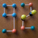 Molecular model atom beads and rods connected to form the digits nine and two.